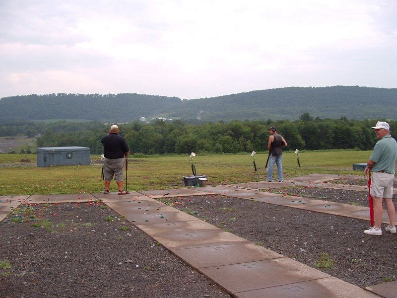 dscf0100z.jpg - After 100 targets in the shoot off, there were two left... Dave Shaeffer (MD) and Dave Bicknell (CT). Do you see the daylight? Good... because by the time they're done, after the rain, gun problems, both shooters running out of shells, an accidental mis fire by Dave Bicknell during the 13th round of shoot off and an approaching 10pm curfew, the daylight is gone and all thats left is some rain, black darkness and orange puff balls.